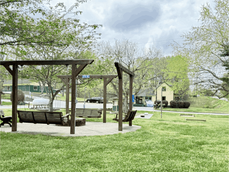 Community Campfire Ring with Bench Swings and Campground Store